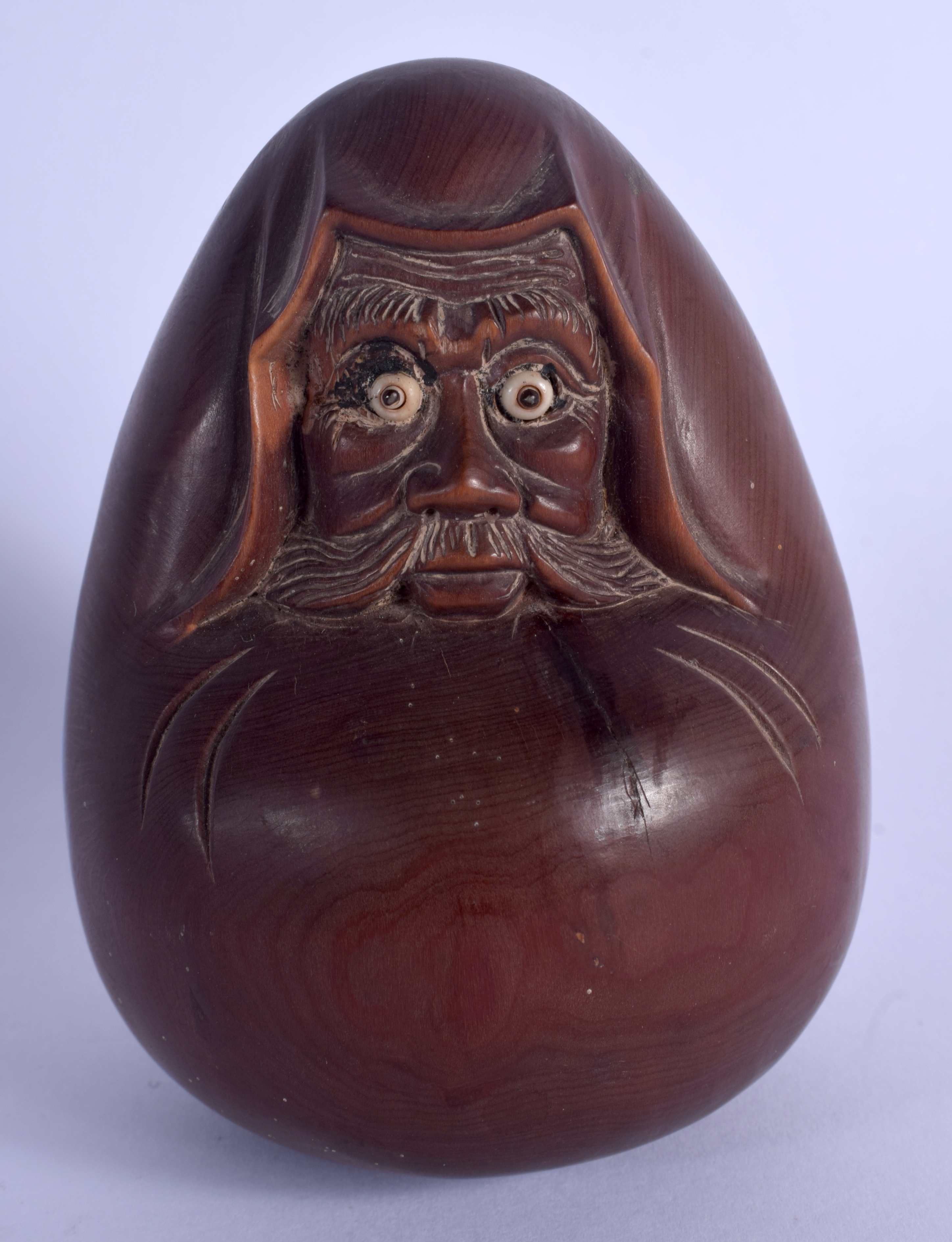 A JAPANESE TAISHO PERIOD CARVED WOOD DARUMA DOLL with pop out eyes. 11 cm x 7 cm.