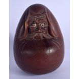 A JAPANESE TAISHO PERIOD CARVED WOOD DARUMA DOLL with pop out eyes. 11 cm x 7 cm.