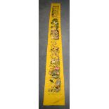 A LONG 19TH CENTURY CHINESE YELLOW SILK EMBROIDERED PANEL Qing, decorated with hundreds of birds wit