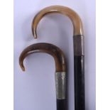 TWO 19TH CENTURY CONTINENTAL CARVED RHINOCEROS HORN HANDLED WALKING CANES. 88 cm long. (2)