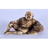 A 19TH CENTURY JAPANESE MEIJI PERIOD CARVED IVORY NETSUKE modelled as a male leaning upon a sack. 4.