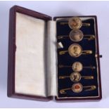 SIX CASED ANTIQUE ENAMELLED PIN BADGES including the Franco British Exhibition 1908. (6)