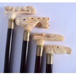 FOUR CONTINENTAL CARVED BONE WALKING CANES with ebonised shafts. Largest 95 cm long. (4)
