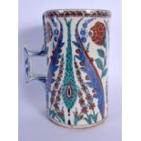 A CONTINENTAL IZNIK TYPE FAIENCE POTTERY CARAFE JUG painted with stylised flowers and vines. 21 cm h