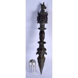 A LARGE CHINESE TIBETAN BRONZE PHURBA modelled with buddhistic mask heads. 60 cm long.
