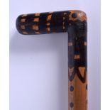 AN UNUSUAL EARLY 20TH CENTURY PAINTED WOOD WALKING CANE with dimple decoration. 84 cm long.