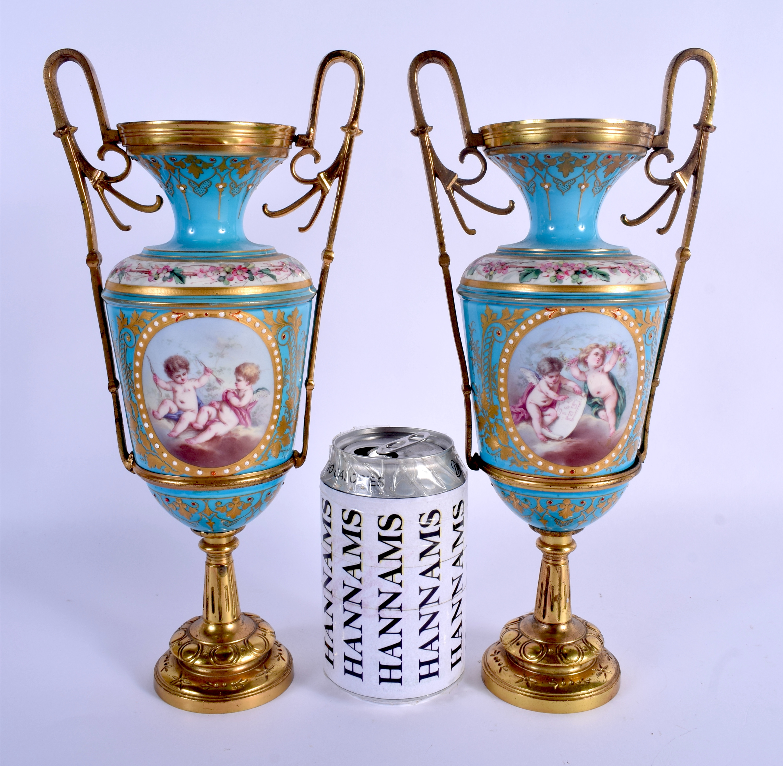 A PAIR OF 19TH CENTURY FRENCH SEVRES PORCELAIN VASES painted and jewelled with putti in various purs