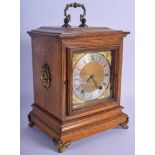 AN ANTIQUE BRASS AND OAK MANTEL CLOCK with lion mask heads. 32 cm x 16 cm.