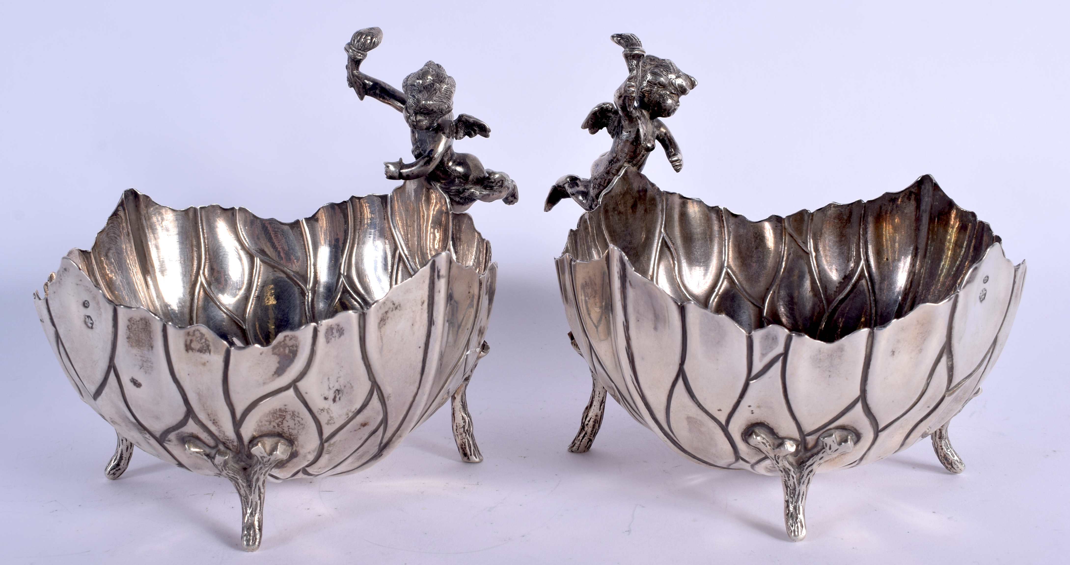A PAIR OF EARLY 20TH CENTURY SILVER CHERUB BOWLS formed as open flowers. 640 grams. 13 cm x 15 cm.