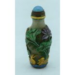Chinese Peking Glass snuff bottle decorated in relief with lotus and frogs 8 cm.