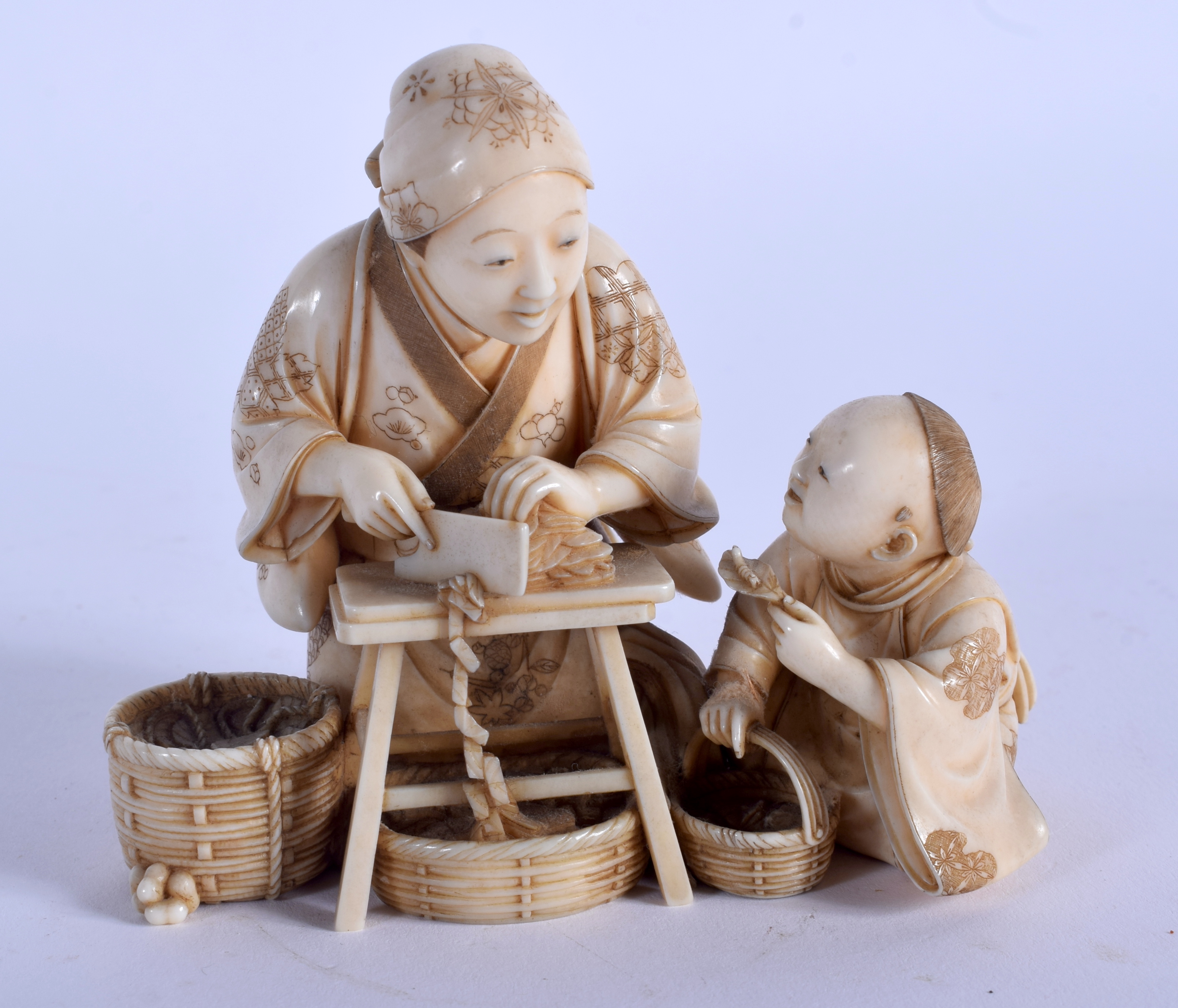 A FINE 19TH CENTURY JAPANESE MEIJI PERIOD CARVED IVORY OKIMONO modelled as a female and child prepar