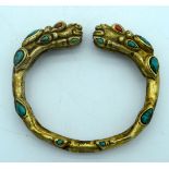 A yellow metal dragon bracelet with Turquoise stone 8 x 7 cm.