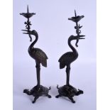A PAIR OF 19TH CENTURY JAPANESE MEII PERIOD BRONZE CANDLESTICKS modelled as birds upon a beast. 21 c