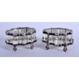 A PAIR OF ANTIQUE SILVER AND CRYSTAL GLASS SALTS. 6 cm x 5 cm.