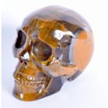 A CHINESE CARVED TIGERS EYE MODEL OF A SKULL 20th Century. 8.5 cm x 7 cm.