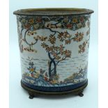 A large European glazed pot in a Chinese style decorated with foliage mounted on a bronze stand 29 x