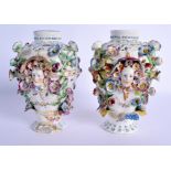 A PAIR OF 18TH CENTURY CHELSEA RETICULATED PORCELAIN VASES encrusted with flowers and mask heads. 21