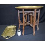 A large Middle Eastern embossed brass tray on a stand together with another 58cm (2).