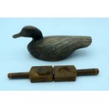 A vintage hand carved wooden decoy and a fruit press. 29cm (2).