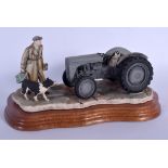 A BORDER FINE ARTS FIGURE OF A MAN AND SHEEP DOG beside a tractor. 23 cm x 15 cm.
