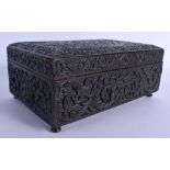 A MIDDLE EASTERN INDIAN CARVED WOOD BOX AND COVER decorated with scrolling foliage. 28 cm x 15 cm