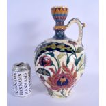 AN ANTIQUE HUNGARIAN ZSOLNAY PECS POTTERY EWER painted with stylised flowers and vines. 32 cm high.