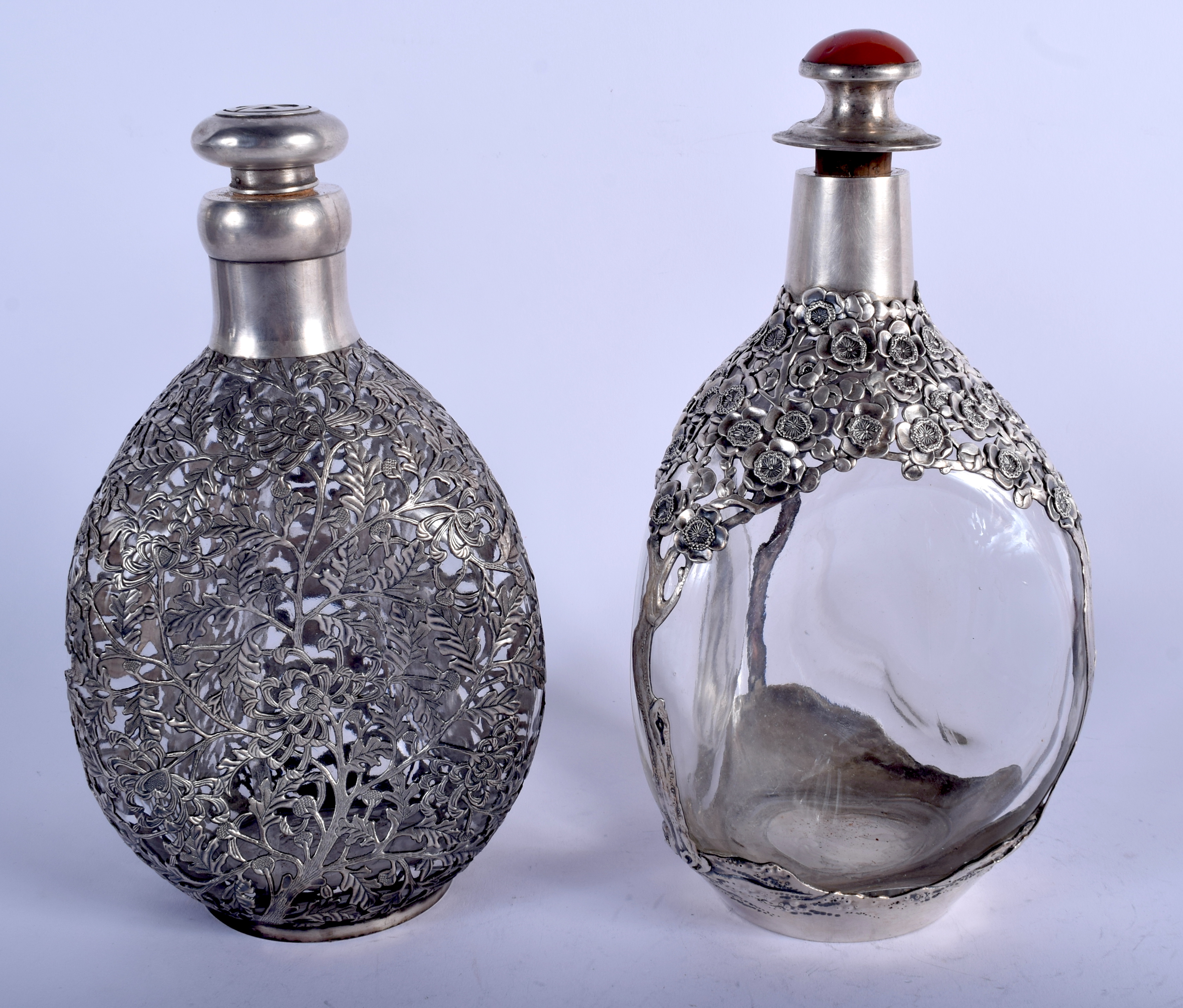 TWO EARLY 20TH CENTURY CHINESE EXPORT SILVER OVERLAID WHISKEY DECANTERS decorated with flowers. 800