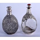 TWO EARLY 20TH CENTURY CHINESE EXPORT SILVER OVERLAID WHISKEY DECANTERS decorated with flowers. 800