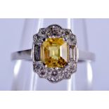 A CHARMING PLATINUM DIAMOND AND YELLOW SAPPHIRE RING. O. 5 grams.