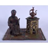 A CONTEMPORARY COLD PAINTED BRONZE FIGURE OF A MALE modelled beside a table. 14 cm x 11 cm.
