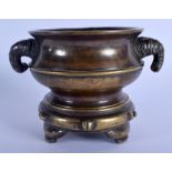A RARE 19TH CENTURY CHINESE BRONZE CENSER ON STAND Qing, formed with bamboo type handles, of natural