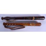 TWO 19TH CENTURY PAINTED WOOD TRUNCHEON one stamped M Norton of Glasgow. Largest 46 cm long. (2)