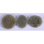 THREE CHINESE CARVED JADE PLAQUE PENDANTS 20th Century, in various forms and sizes. Largest 5 cm x 5