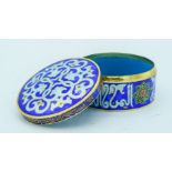 A small enamelled metal Islamic lidded box 8 x 4cm.