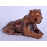 A JAPANESE BOXWOOD FIGURE OF A RECLINING TIGER. 14 cm x 8 cm.