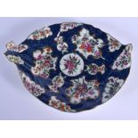 18th c. Worcester cos lettuce leaf shaped dish painted with flowers on a blue scale ground. 26cm lo