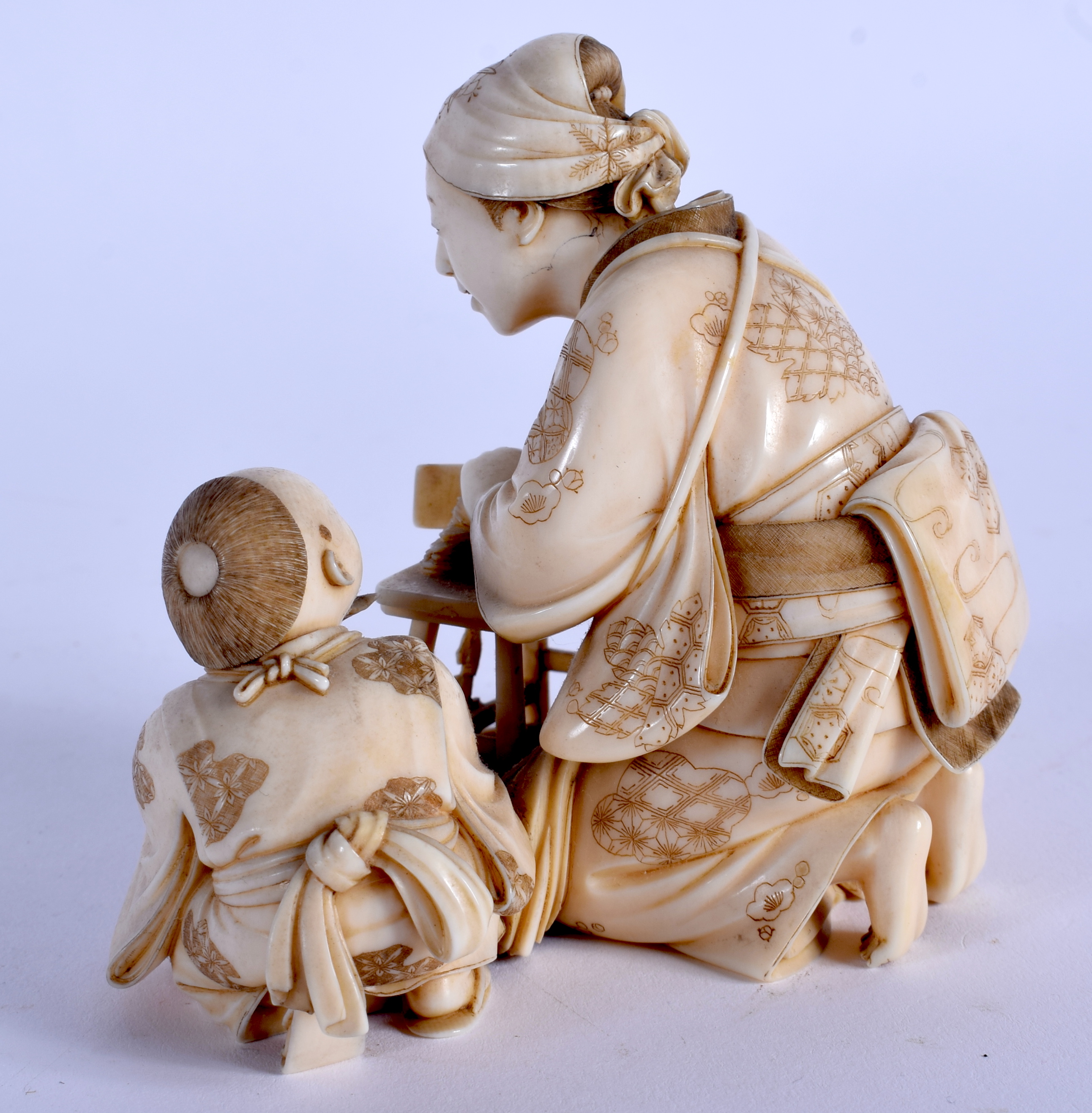 A FINE 19TH CENTURY JAPANESE MEIJI PERIOD CARVED IVORY OKIMONO modelled as a female and child prepar - Image 2 of 4