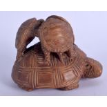 A JAPANESE CARVED WOOD FIGURE OF A TORTOISE modelled with three tortoise upon its back. 10 cm x 8 cm