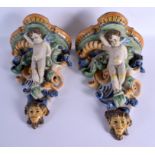 A LARGE PAIR OF 19TH CENTURY ITALIAN MAJOLICA POTTERY WALL BRACKETS formed with figures over mask he