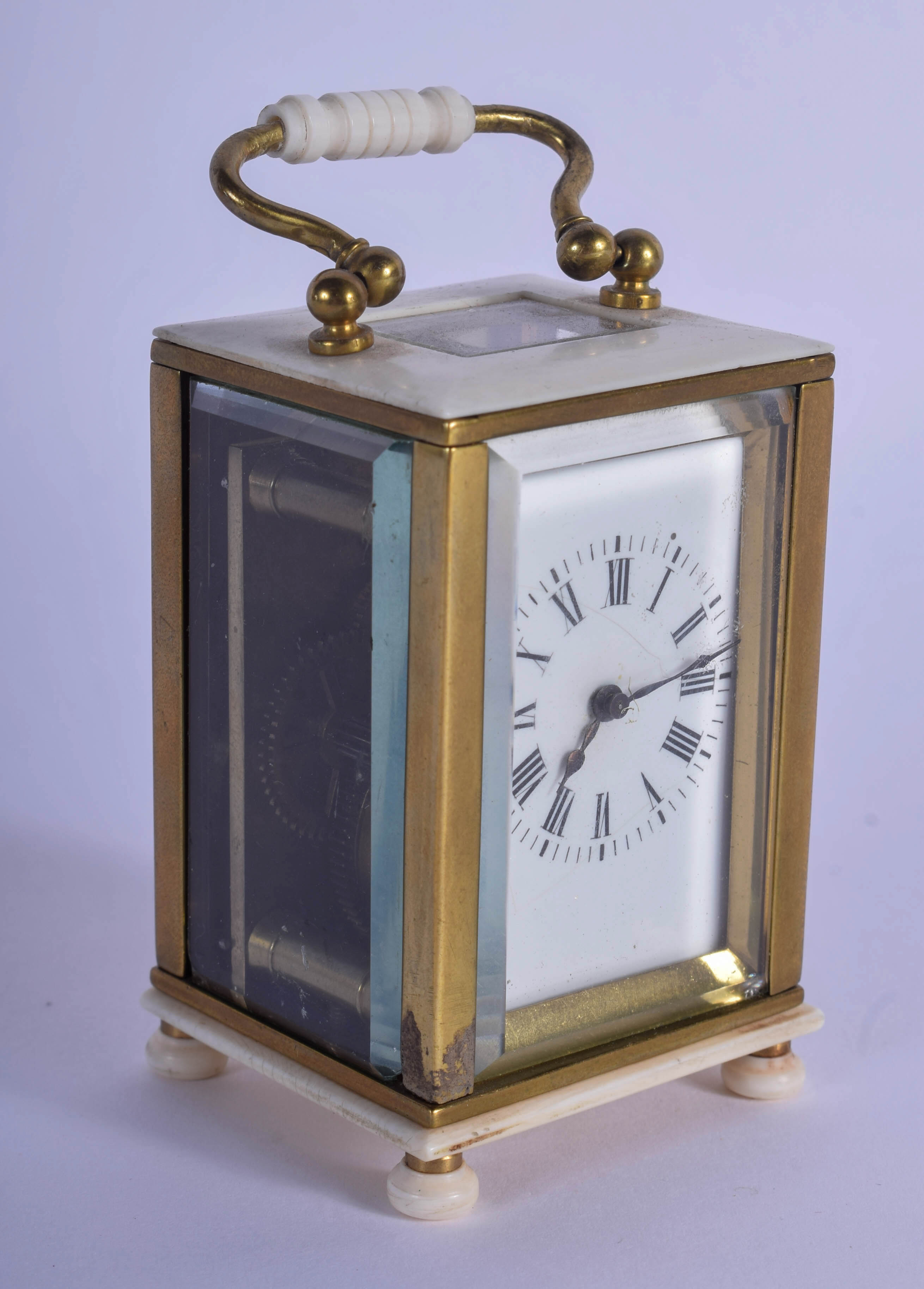 A 19TH CENTURY EUROPEAN MINIATURE CARVED IVORY CARRIAGE CLOCK of plain form. 9 cm high inc handle.