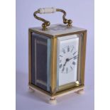 A 19TH CENTURY EUROPEAN MINIATURE CARVED IVORY CARRIAGE CLOCK of plain form. 9 cm high inc handle.