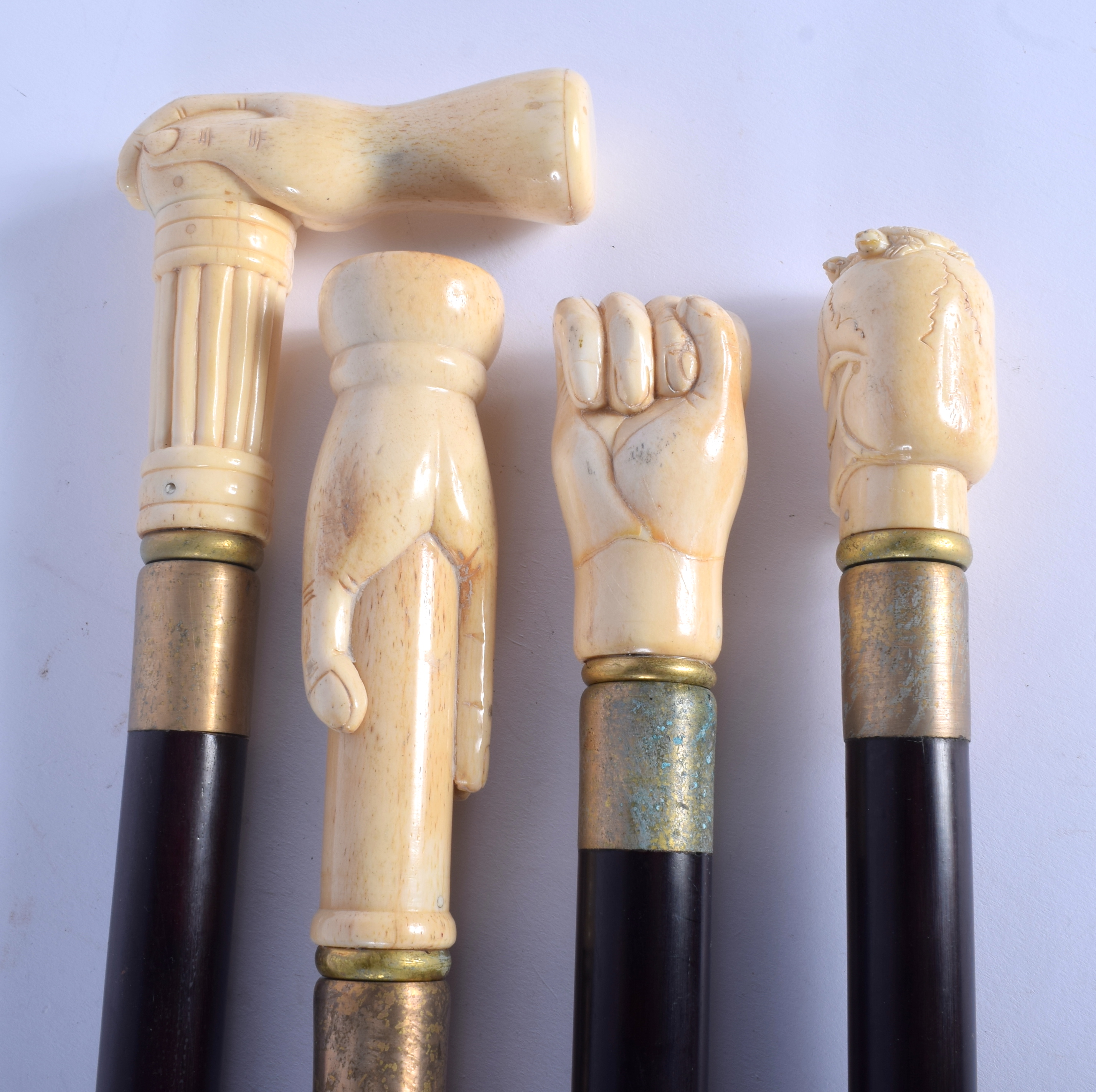 FOUR CONTINENTAL CARVED BONE WALKING CANES with ebonised shafts. Largest 95 cm long. (4) - Image 2 of 3