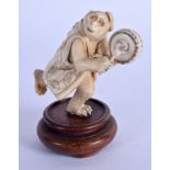 A 19TH CENTURY JAPANESE MEIJI PERIOD CARVED IVORY OKIMONO modelled beating a drum. Ivory 6 cm x 4 cm