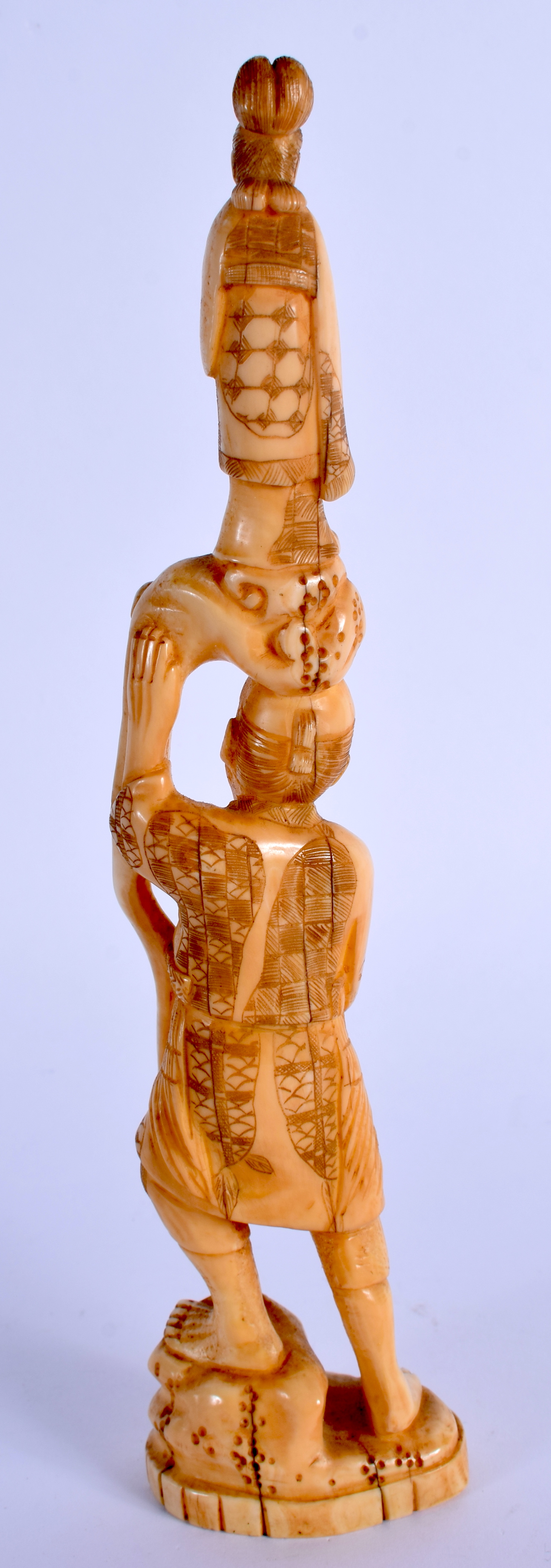 A 19TH CENTURY JAPANESE MEIJI PERIOD CARVED IVORY OKIMONO modelled holding aloft a female. 23.5 cm h - Image 2 of 3