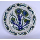 A MIDDLE EASTERN TURKISH FAIENCE IZNIK POTTERY PLATE painted with green and blue foliage. 33 cm diam