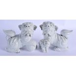 A PAIR OF 19TH CENTURY CHINESE PORCELAIN BUDDHISTIC LIONS modelled standing upon an orb and a young