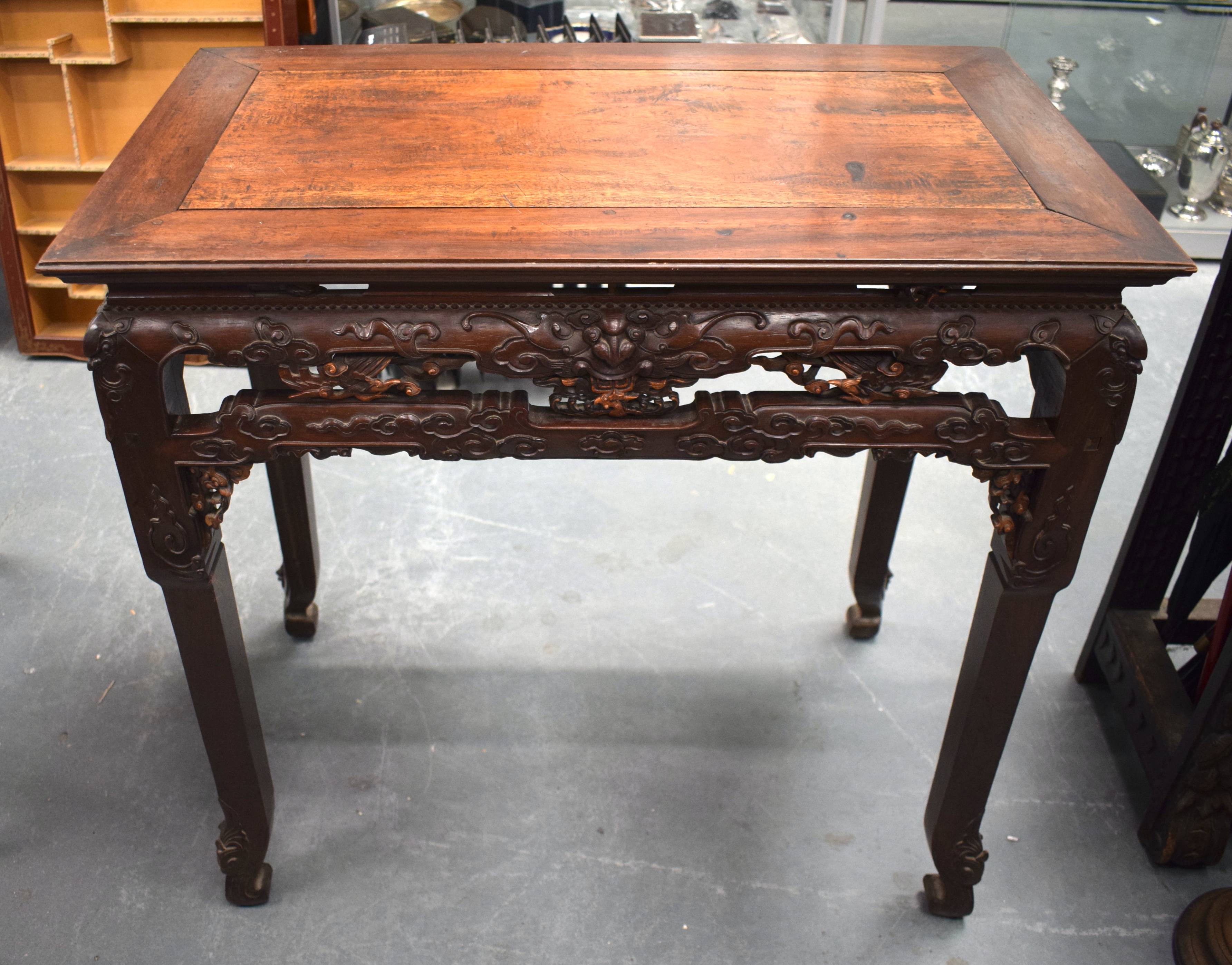 A FINE 19TH CENTURY CHINESE CARVED HONGMU HARDWOOD TABLE Qing, carved with mask heads and extensive