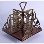 AN ART NOUVEAU BRASS AND HARDWOOD SPINNING STAND upon a square form base. 23 cm x 32 cm.