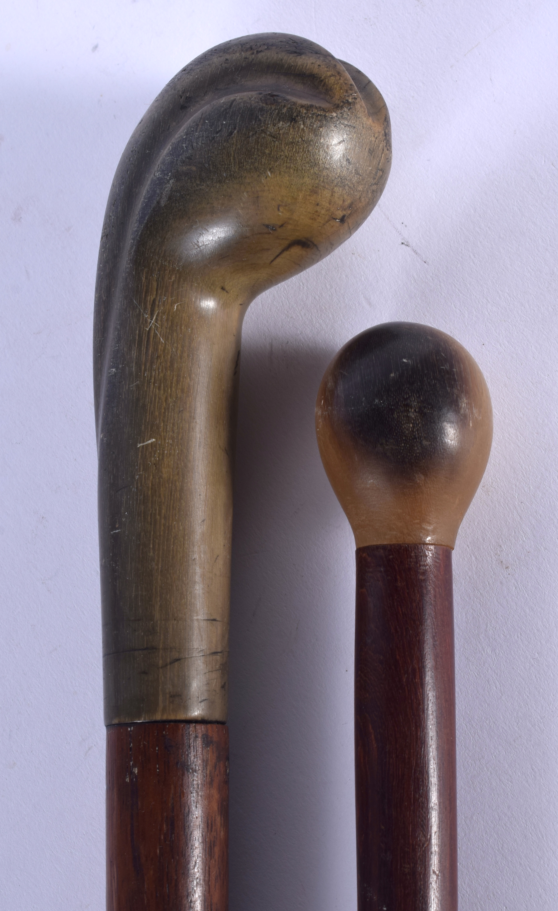 TWO 19TH CENTURY CONTINENTAL CARVED RHINOCEROS HORN HANDLED WALKING CANES. 88 cm long. (2) - Image 2 of 3