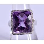 A 14CT GOLD DIAMOND AND AMETHYST RING.7 grams. O.